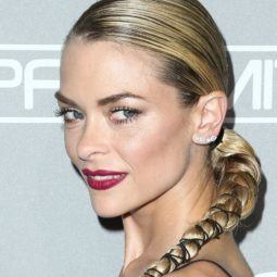 shot of jamie king with party braids that have been wrapped with ribbon, wearing black on the red carpet