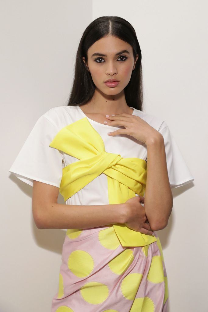 woman backstage at new york fashion week with long sleek brunette hair