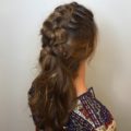 back shot of a woman with long brunette hair in a mohawk braid style