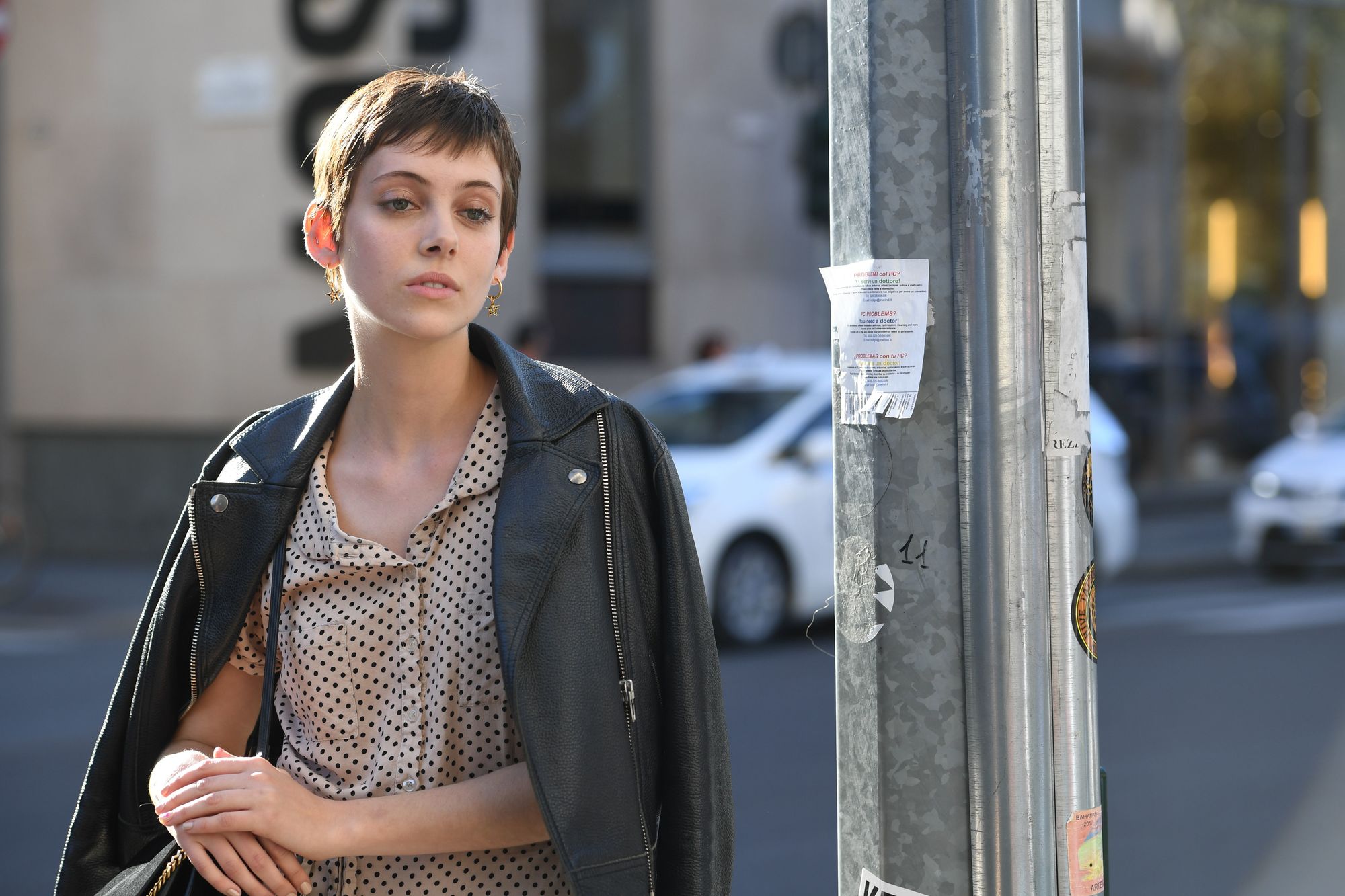 Milan Fashion Week Street Style FW19: Woman with short brown pixie cut wearing a leather jacket.