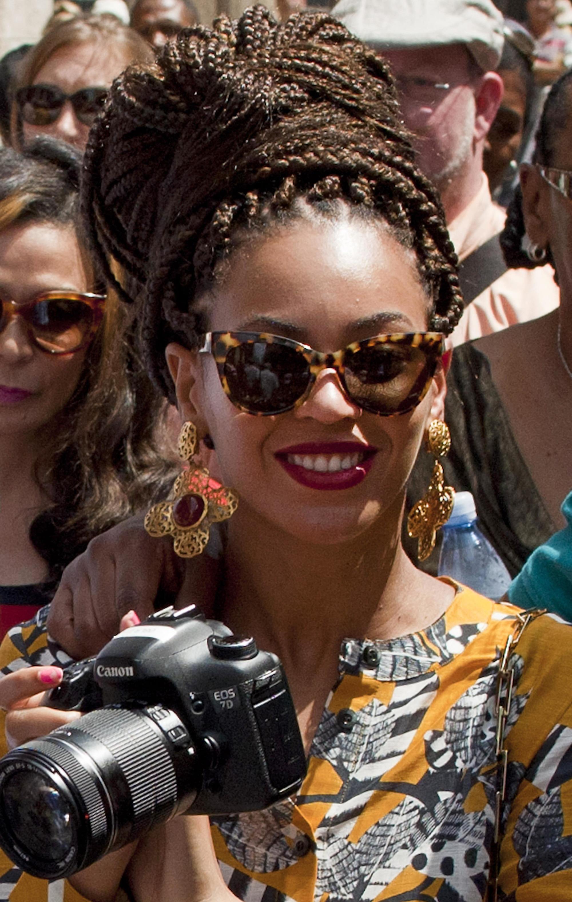 Beyonce with brown hair in box braid wrap bun