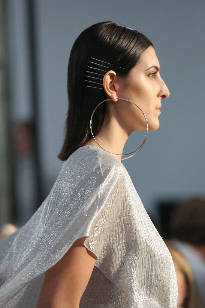 woman on the runway of sally la pointe ss18 with silver accessories and sleek brunette hair