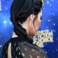 side shot of olivia munn with side fishtail braid hairstyle with a cuff on it on the red carpet