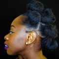 side shot of woman with kinky weave styled into bantu knots