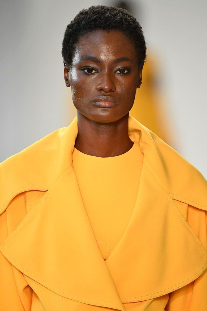 model on NYFW runway with short afro style