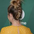 backshot of ashley tisdale with an upside down braided updo on the red carpet, wearing yellow