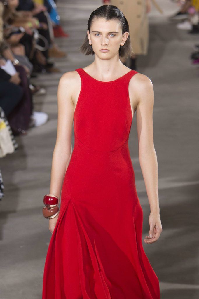 model on NYFW runway with brown long bob hair smoothed back in wet look finish