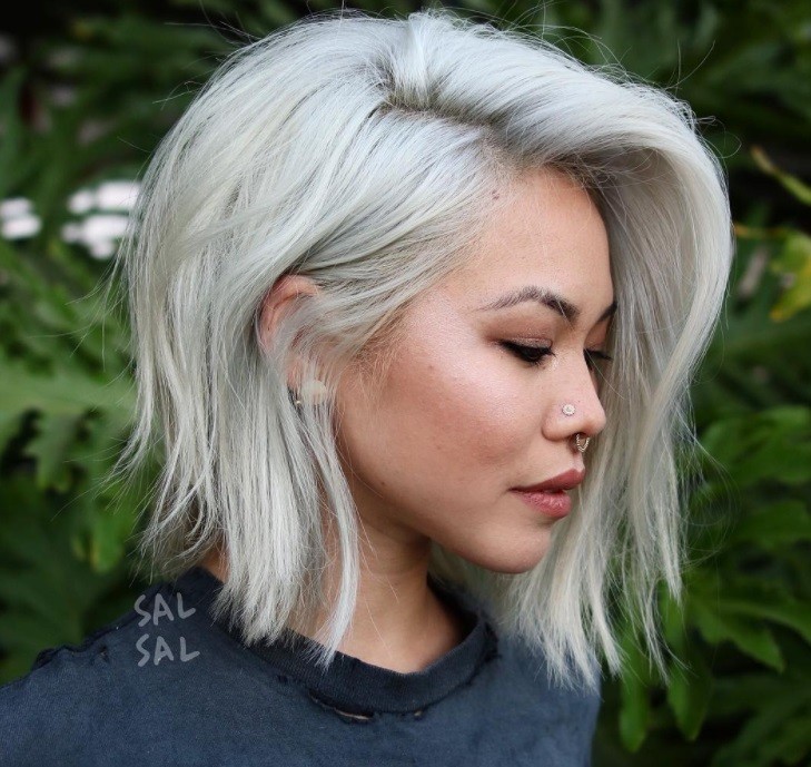 woman with grey a line with bangs hairstyle posing outside