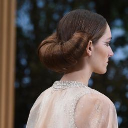 backshot of model on the chanel runway with a crossiant bun hairstyle