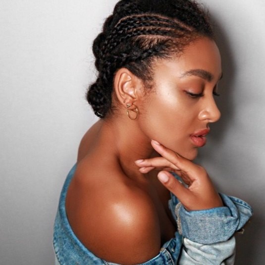 side profile of a woman with cornrows