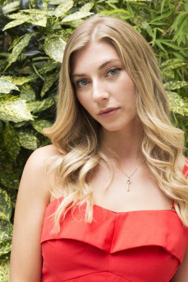 How to curl your hair with a curling wand: Final look of blonde model wearing a red dress
