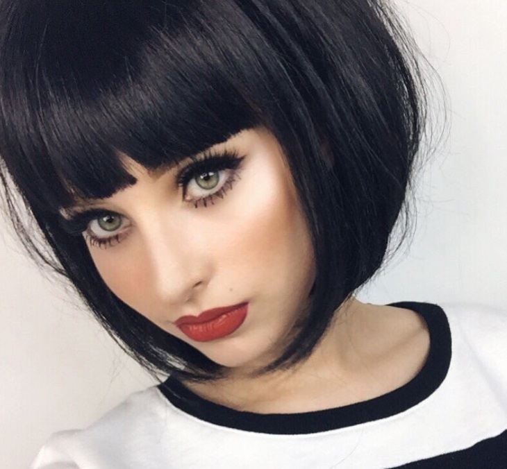 woman with an a lone bob with blunt bangs in a dark brown