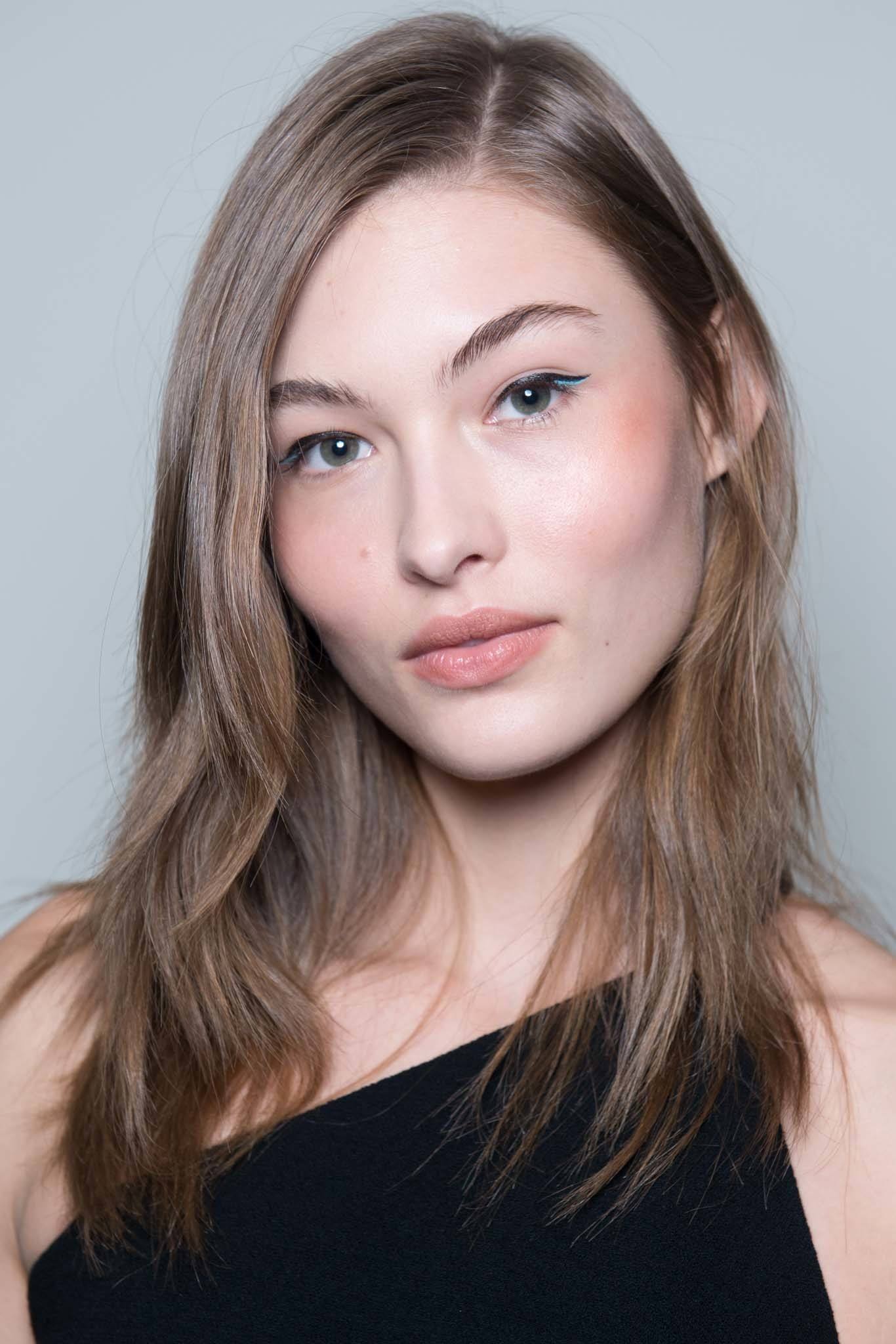 close up shot of model with straight, fuller strands that have a slight bend at the ends