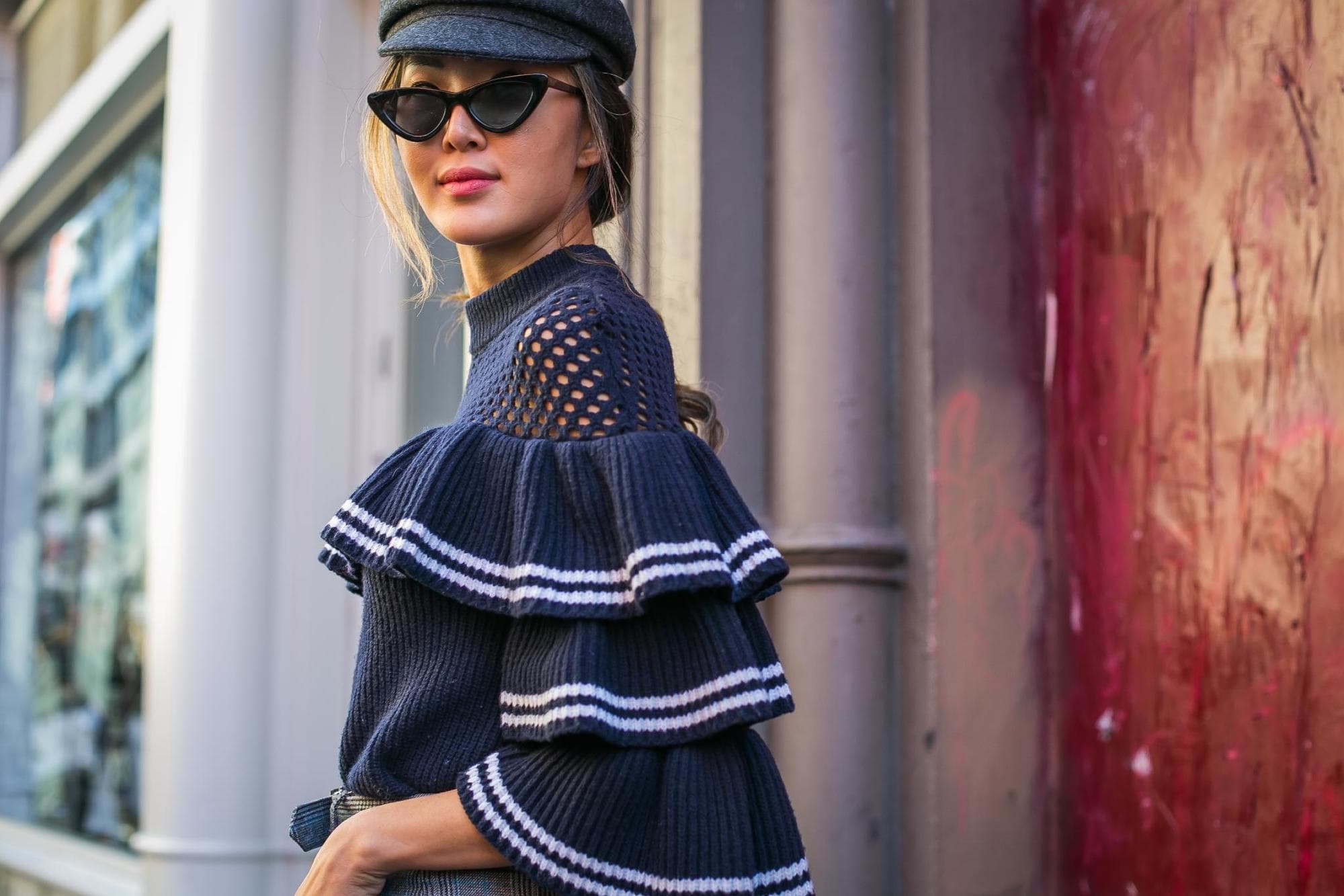baker boy hat trend: close up shot of woman with low ponytail and baker boy hat, on the street