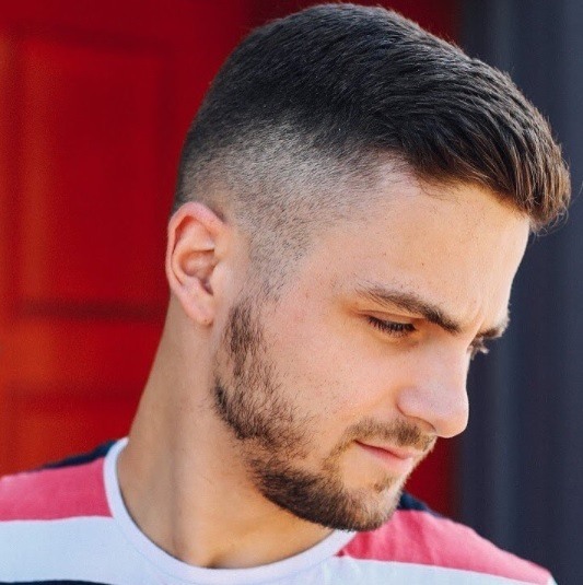 side profile shot of a man with a classic crew cut and fade detail