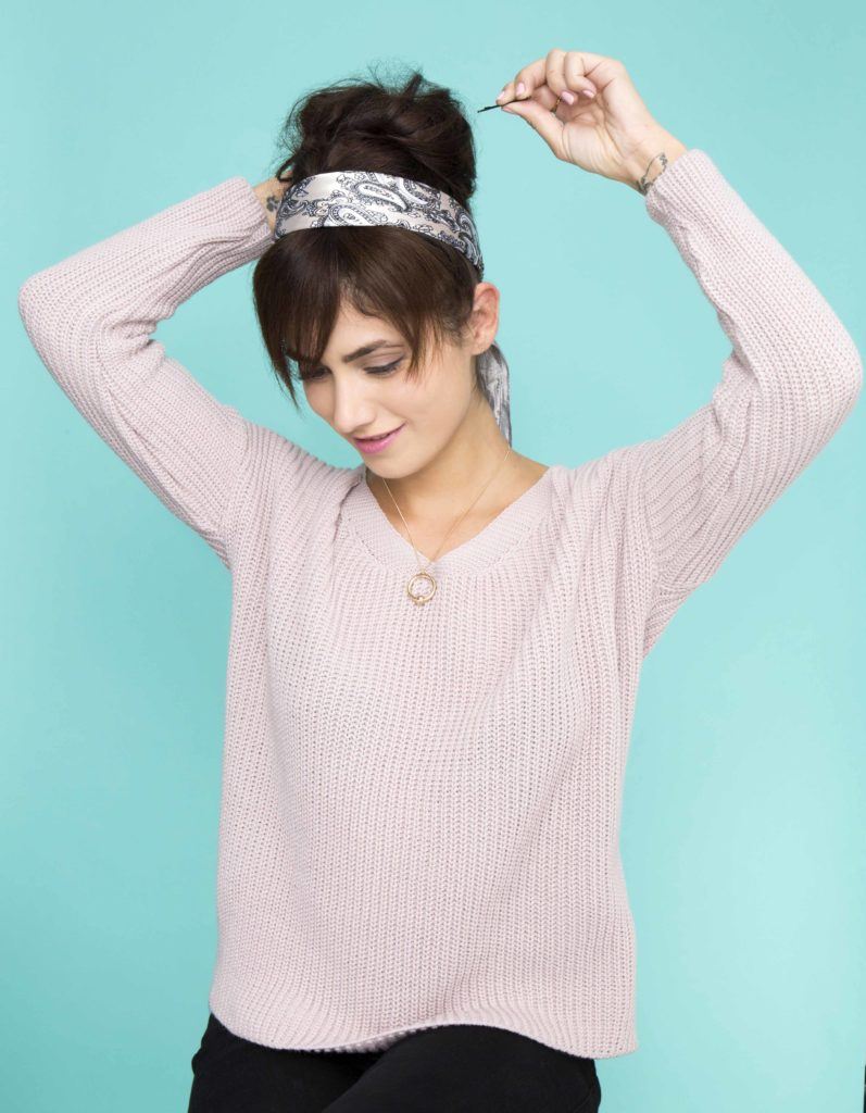 front view of brunette model securing updo with hair grips