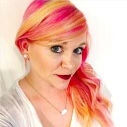 selfie of a woman with yellow and pink fruit salad inspired hair