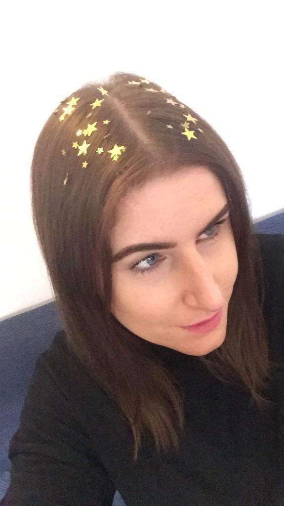 front view of Leon with gold star roots on medium length brown straight hair