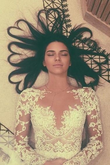 birds eye view of kendall jenner with long dark hair in love heart shapes