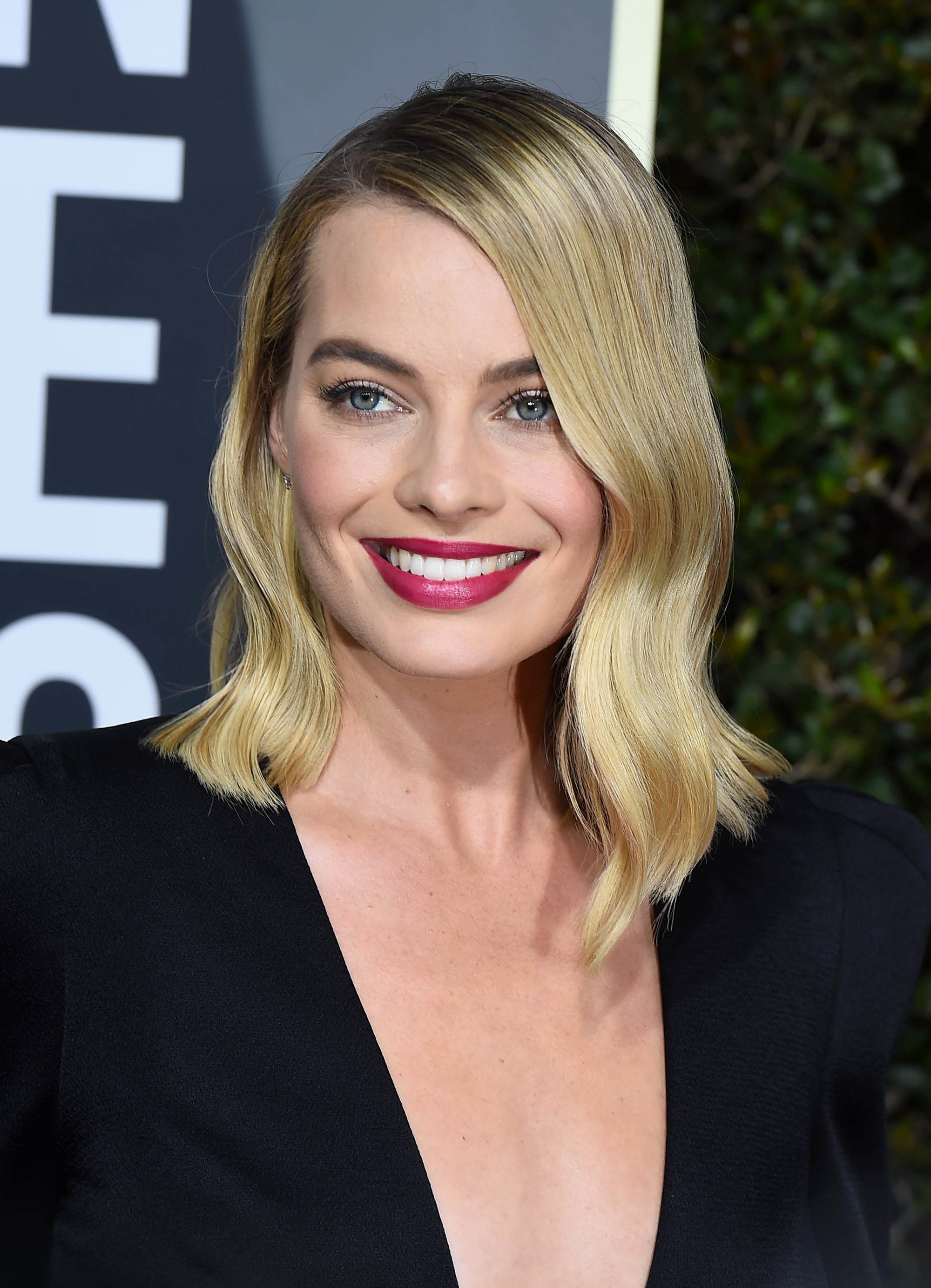 Blonde hair: Close up shot of Margot Robbie with golden blonde hair mid-length wavy hair.
