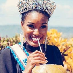 close up shot of miss jamaica's davina bennet, wearing crown and miss universe sash, with coconut