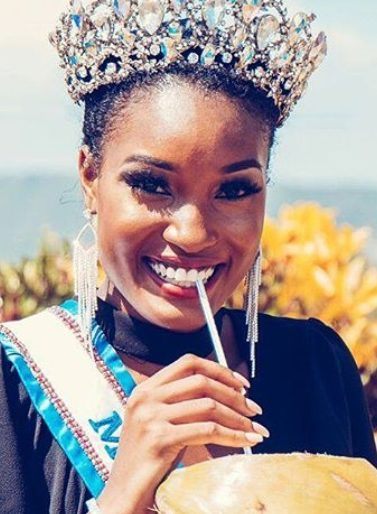 close up shot of miss jamaica's davina bennet, wearing crown and miss universe sash, with coconut