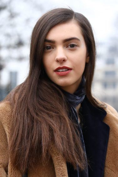 close up shot of woman with long brown hair, wearing winter coat