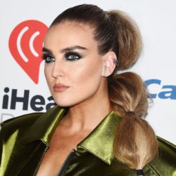 little mix singer perrie edwards in a green silky bomber jacket with her bronde hair in a side bubble ponytail