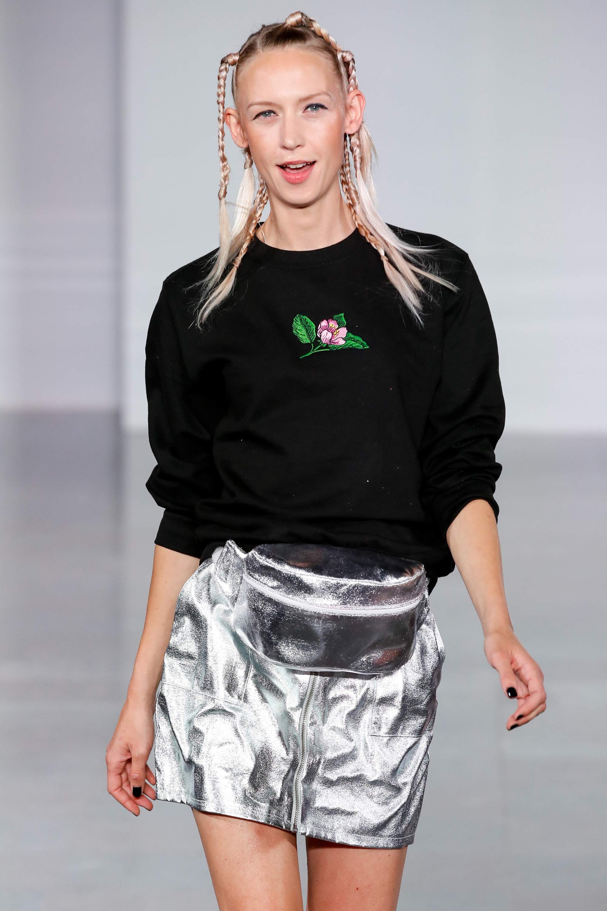 Ideas for crazy hair day: Blonde runway model with her hair in tiny random braids, wearing a black sweatshirt and silver skirt
