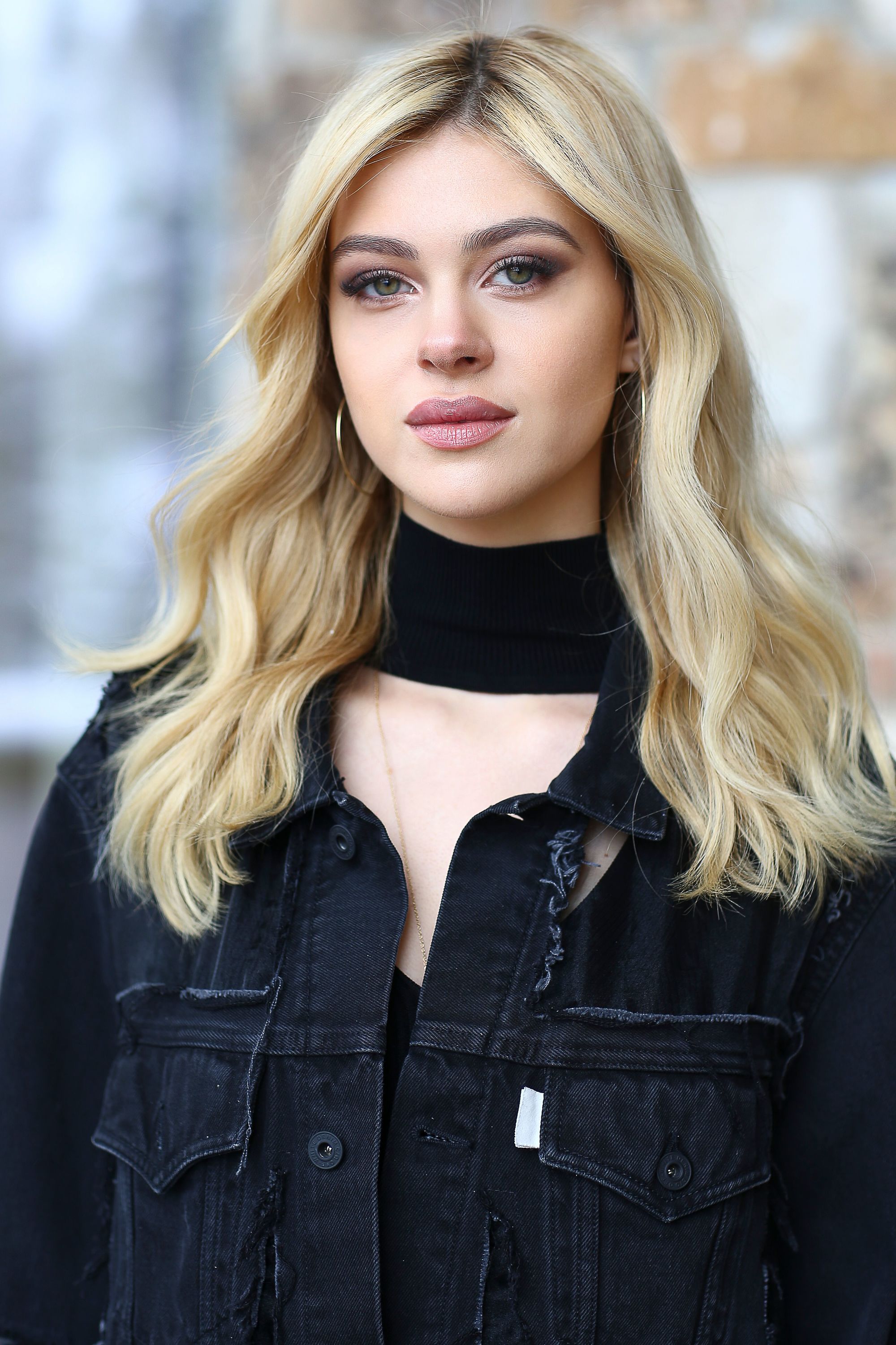 Blonde hair: Close up shot of Nicola Anne Peltz with dark roots and buttery blonde hair.