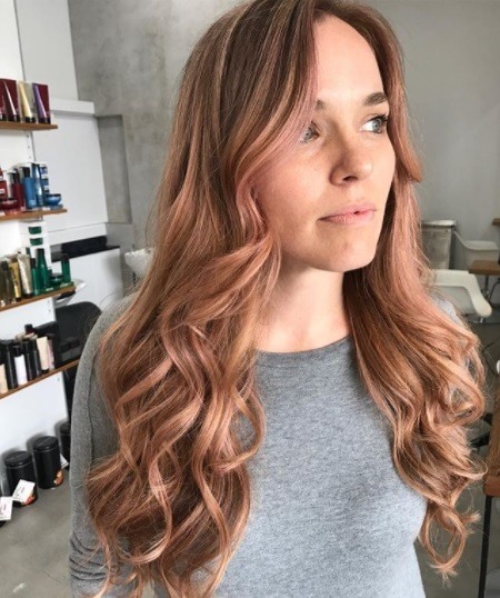 photo of a woman with dark rose gold curly hair