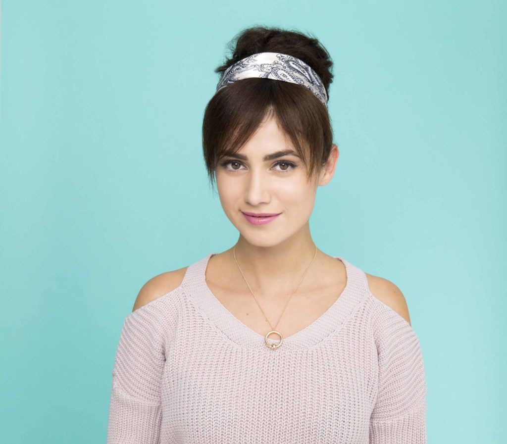 front view of brunette model with fake bangs updo with headband