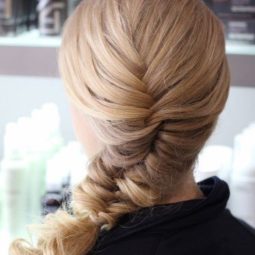 blonde woman with a side fishtail braid hairstyle