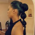 side profile shot of a woman with a slicked back bubble pony hairstyle