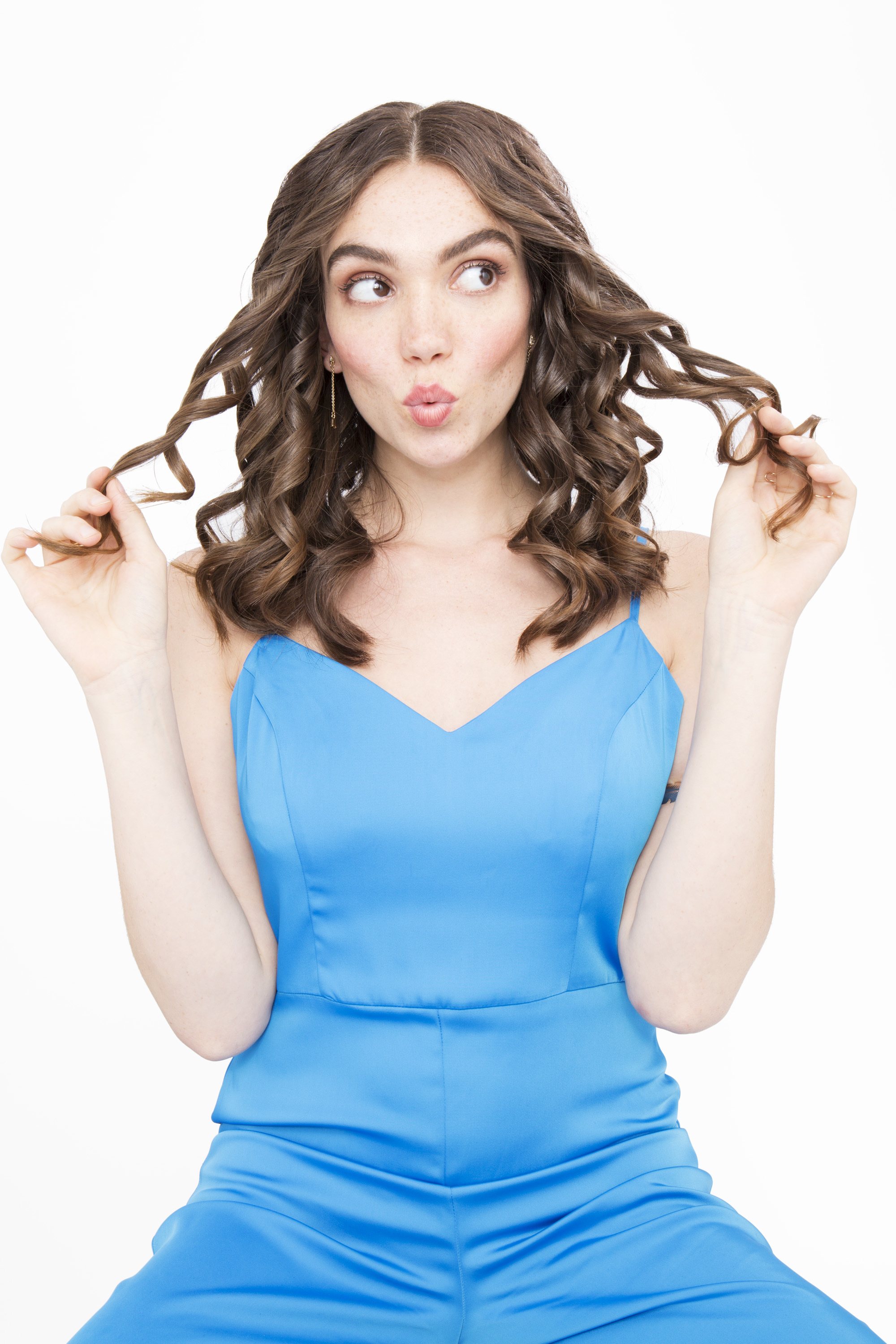 front view of brunette model with brown medium length hair in spiral curls