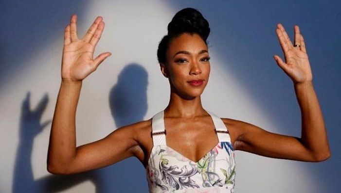 close up shot of star trek: discovery star with vintage updo hairstyle, wearing corset top