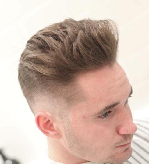 brunette man with quiffed up tousled hair