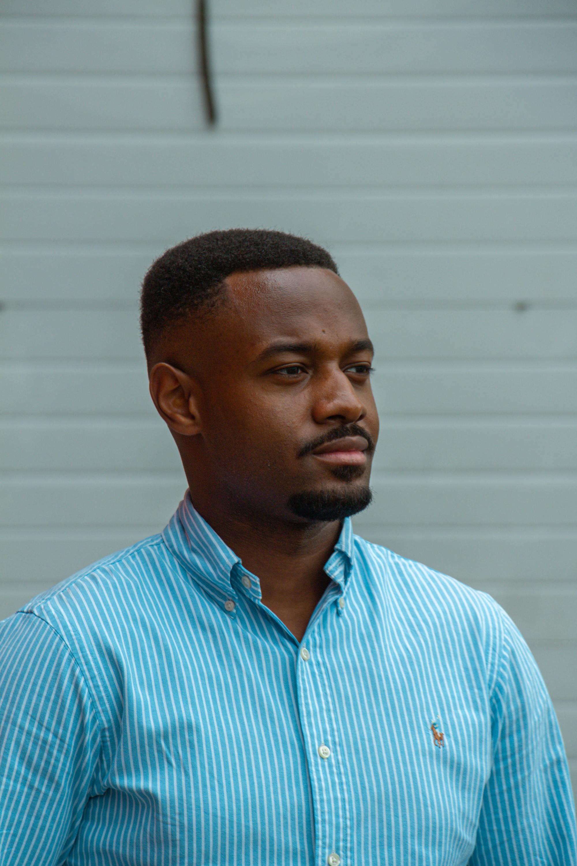 Man with short, fine afro with trimmed beard