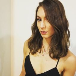 front angled view of Troian Bellisario with medium length brown wavy hair in side parting