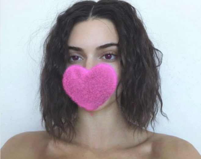 front view of kendall jenner with long bob dark hair with small curls