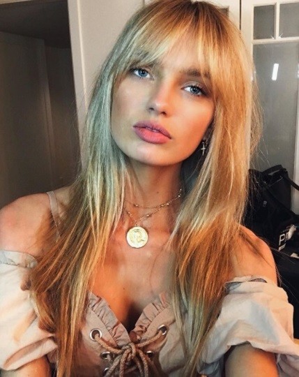 victoria's secret model romee strijd with long golden blonde hair and parted bardot birkin bangs