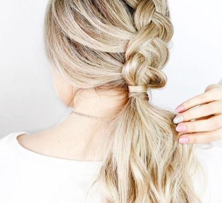 back view of blonde highlighted hair in braided ponytail