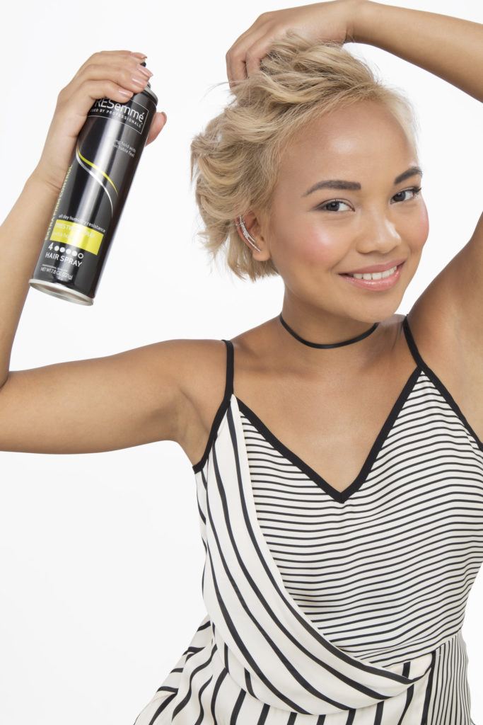 How to curl short hair blonde girl looking at camera using hair spray