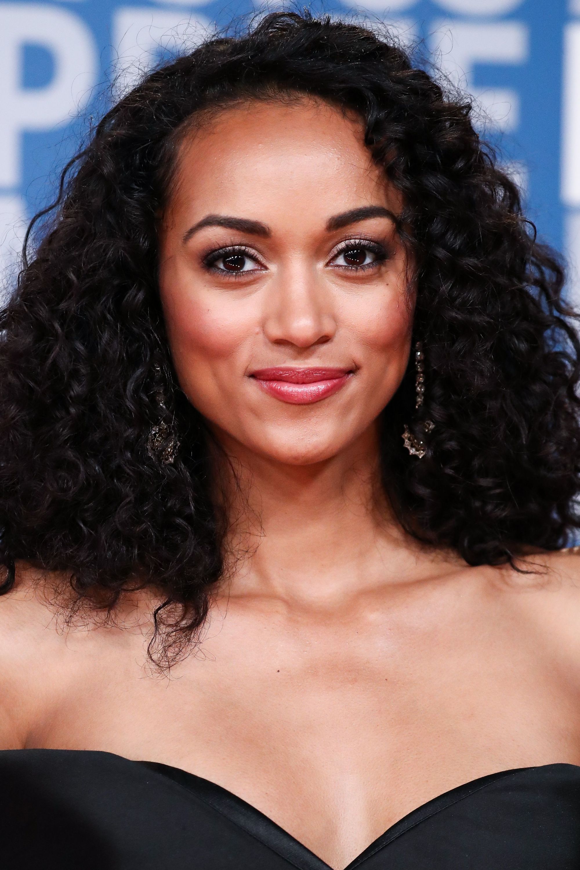 front view of kara mccullough with black curly shoulder length hair