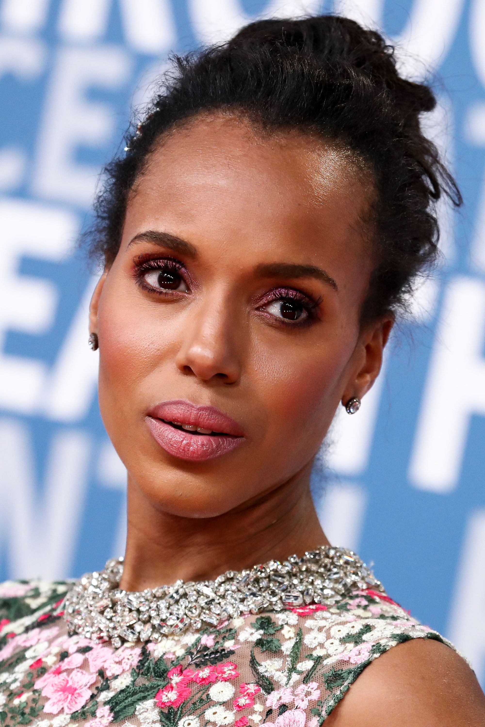 front view of kerry washington black hair in messy high bun updo