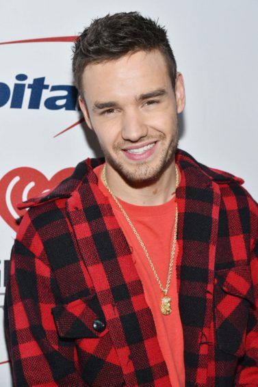 one direction singer liam payne wearing a red checked shirt with his signature cropped hairstyle