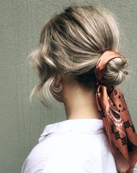 back view of blonde hair in low bun with headscarf