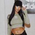 close up shot of maya jama with hat hairstyle, wearing Adidas outfit