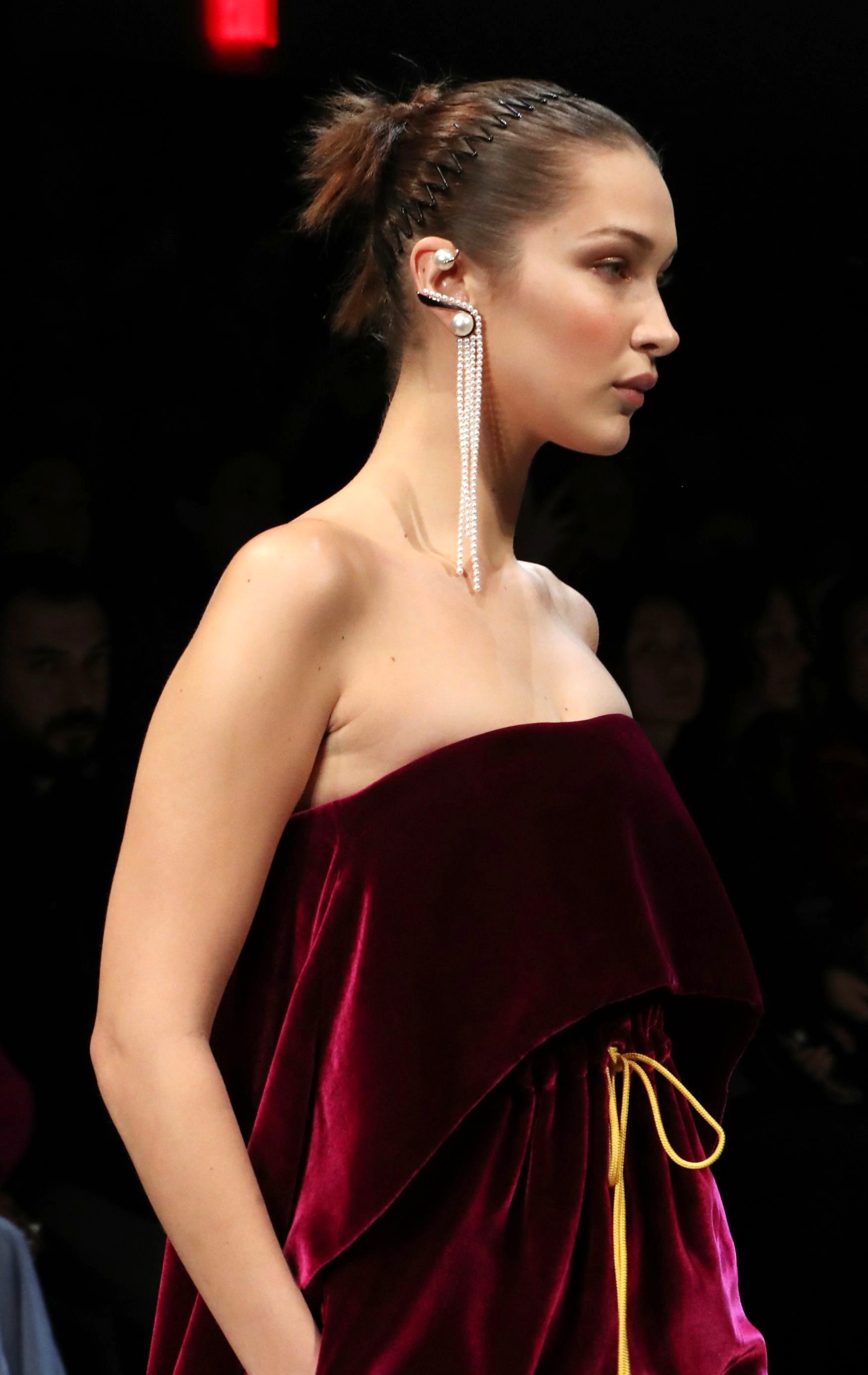bella hadid brown hair in updo with '90s accordion headband on catwalk