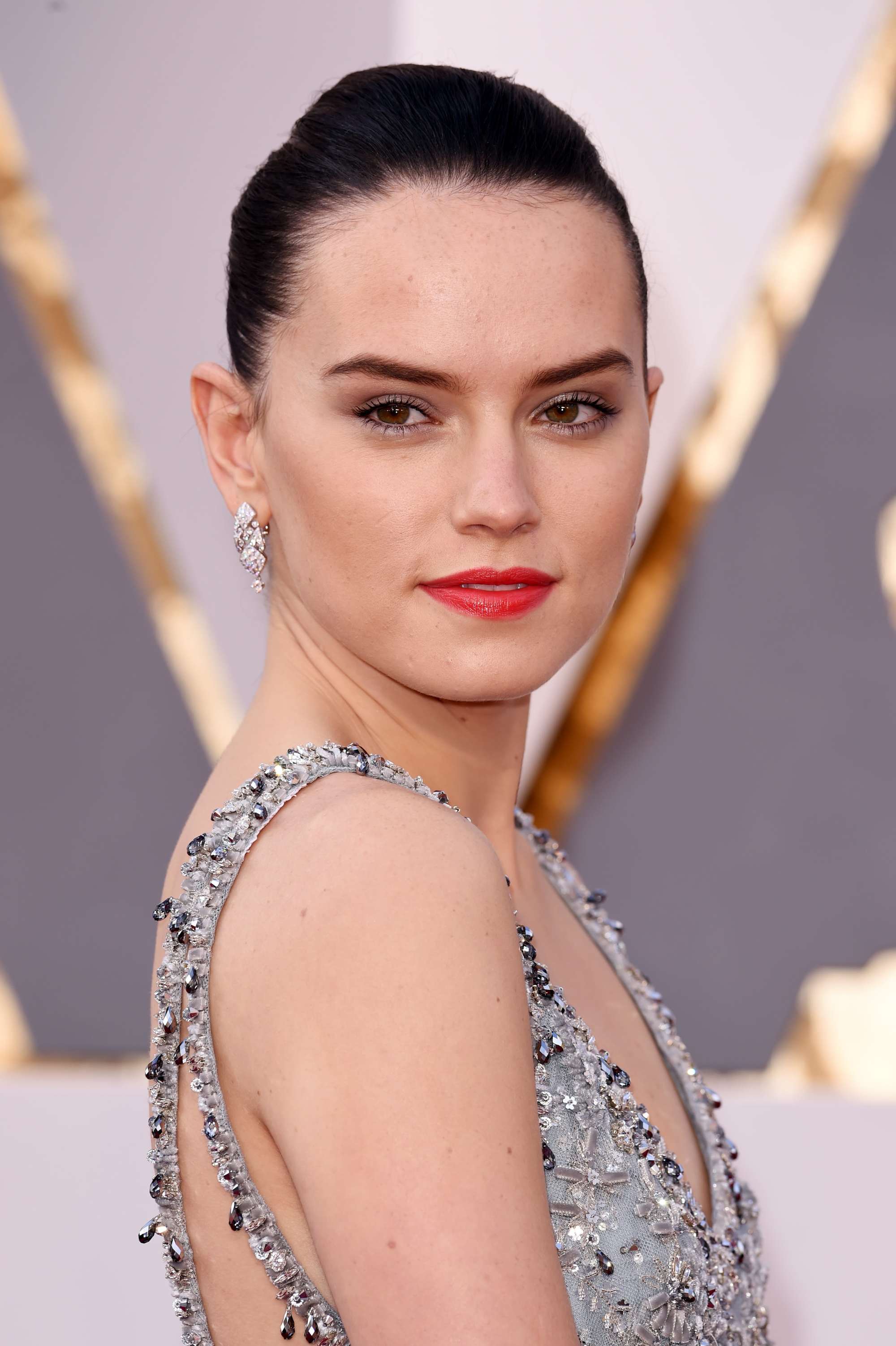 Daisy Ridley with a bun AKA Rey from Star Wars looking over her shoulder at the 88th Annual Academy Awards, Red Carpet Arrivals, Los Angeles, America - 28 Feb 2016